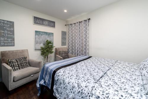 a bedroom with a bed and a chair and a chalkboard at Comfort and Cozy stay Free parking on site in Oakland