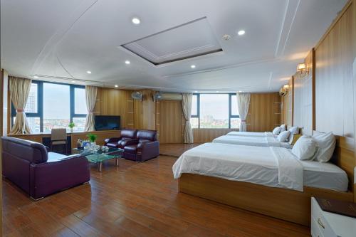 a bedroom with a large bed and a living room at SAILING TOWER Hotel in Khang Qui