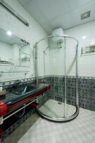 a shower in a bathroom with a sink at SAILING TOWER Hotel in Khang Qui
