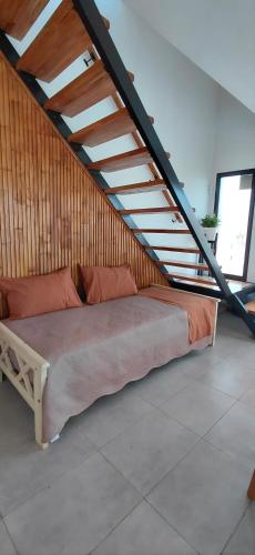 a bed in a room under a staircase at Duplex Frente mar in Playa Dorada