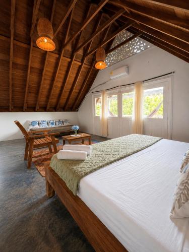 a bedroom with a large bed and a table at Hotel Isla Azul - Islas del Rosario in Isla Grande
