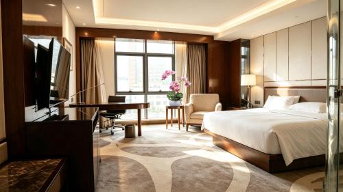 a hotel room with a bed and a desk at Lv Shou Hotel in Shanghai