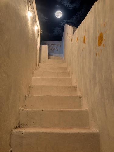 a stairway with a sign on the side of a wall at Por do sol residence in Aracati