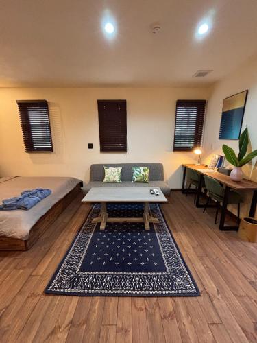 a living room with a couch and a table at WAAP Hotel in Ishigaki Island