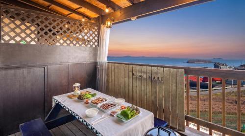 a table with two plates of food on a balcony at Taean anmyeondo hwangdo ilmare Pension in Taean