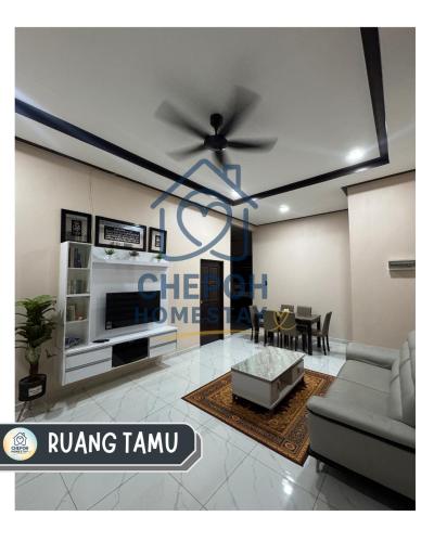 a living room with a couch and a ceiling fan at Chepoh Homestay Pasir Mas in Pasir Mas