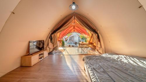 a large room with a bed and a tv at Muju Land Camping Glamping in Muju
