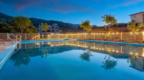 a swimming pool in a resort at night at Muju Land Camping Glamping in Muju