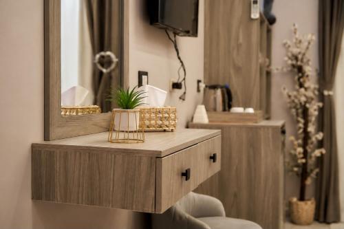 a bathroom with a wooden vanity with a mirror at Golden RZ pyramids view in Cairo