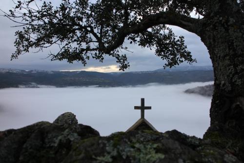 a cross on top of a hill with a lake at Casa do Estevo in Francos