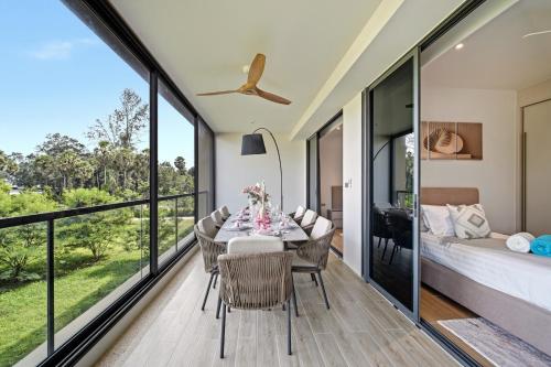 a bedroom and dining room with a table and chairs and a bed at Seashore Beach Residences by NLA in Bang Tao Beach