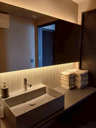 a bathroom with a sink and a mirror at Ciel Bleu in Yamaguchi