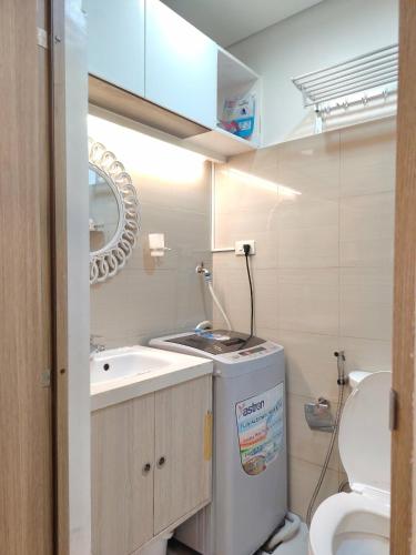 a small bathroom with a sink and a toilet at VP luxury moa staycation in Manila