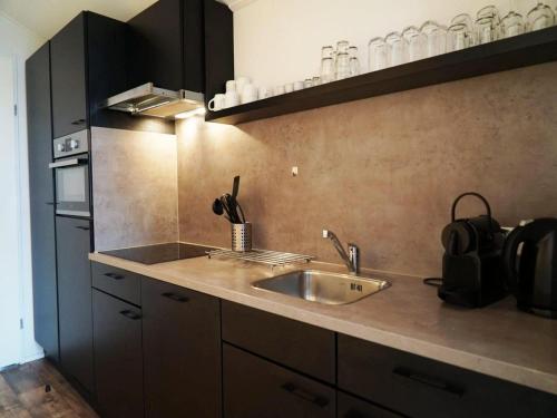 a kitchen with a sink and a counter top at Contemporary Chalet in Kaatsheuvel in Kaatsheuvel