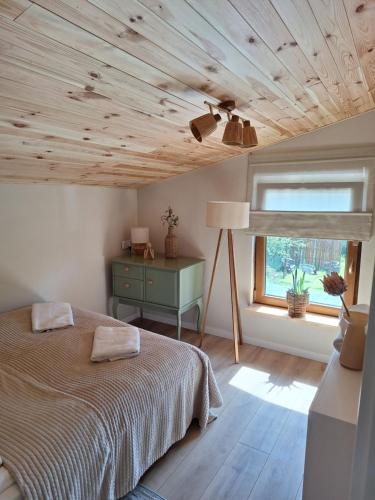 a bedroom with a bed and a window at Nadmorska Przystań in Gdańsk