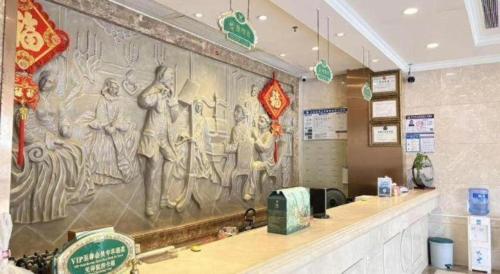 a wall in a fast food restaurant with a mural at Guangna Hotel in Huizhou