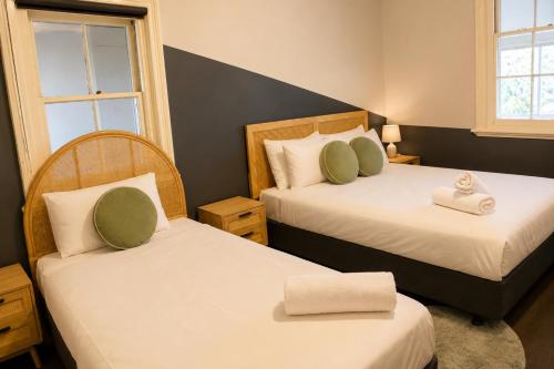 a bedroom with two beds with towels on them at Geraldton Shoreline Lodge in Geraldton