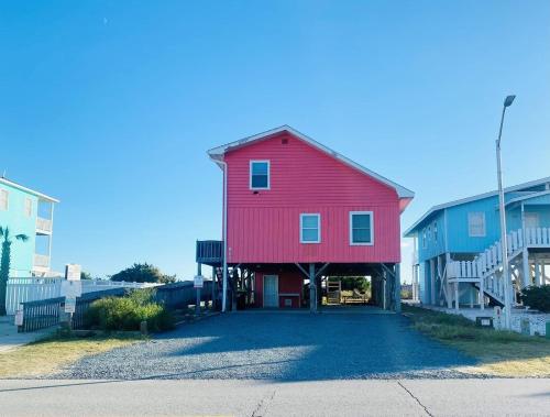 a red barn is on the side of a building at 3 4 Time in Holden Beach