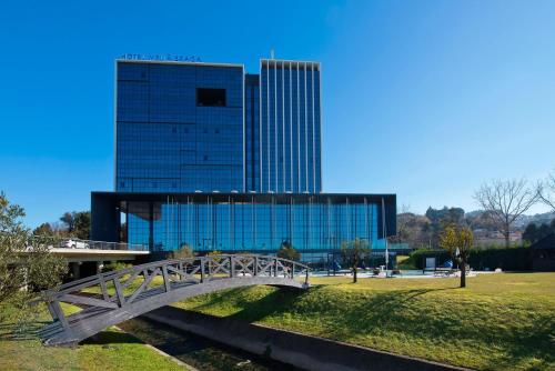 a bridge in front of a building with a tall building at Meliá Braga Hotel & Spa in Braga