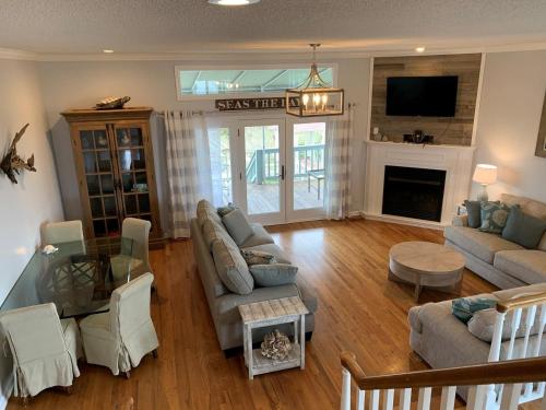 a living room with a couch and a table at Tortuga home in Holden Beach