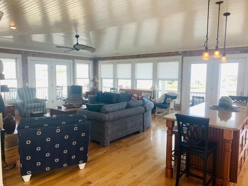a living room with a couch and a table at Shore Beats Workin' in Holden Beach