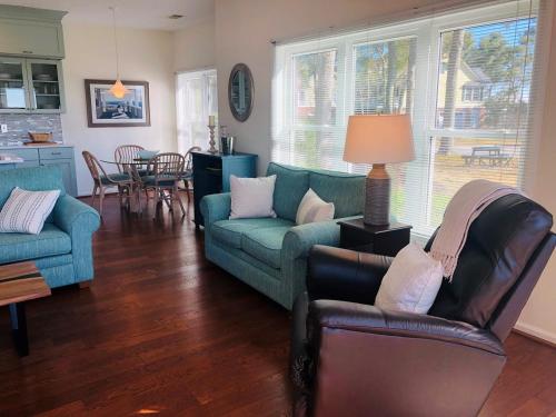 a living room with a couch and chairs and a table at Holden Hideaway condo in Supply