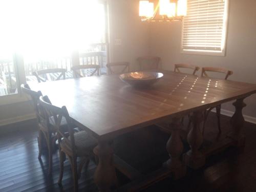 a wooden table with chairs and a bowl on top at Dune Deck South - Duplex in Holden Beach