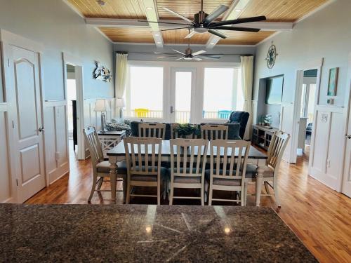 a dining room and living room with a table and chairs at Holden R Breath in Holden Beach