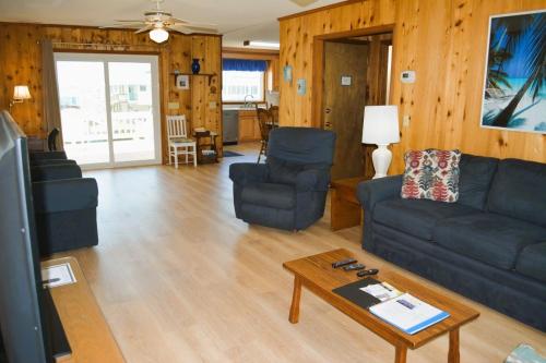 a living room with a couch and chairs and a table at Do-Little Dock in Holden Beach