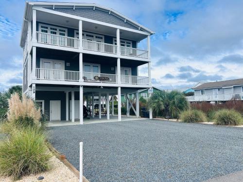 a large apartment building with a driveway in front of it at Compass Rose in Holden Beach