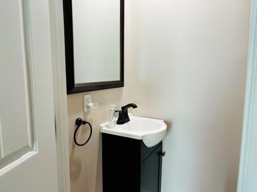 a bathroom with a sink and a mirror at Nauti Time home in Holden Beach