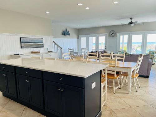 a kitchen and dining room with a table and chairs at Avalon West-Duplex in Holden Beach