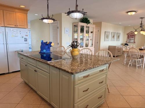 a kitchen with a island with a counter top at Majak Moments in Holden Beach