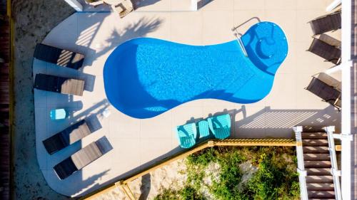 a mural of a swimming pool on the side of a building at Cinnamon Sands home in Holden Beach