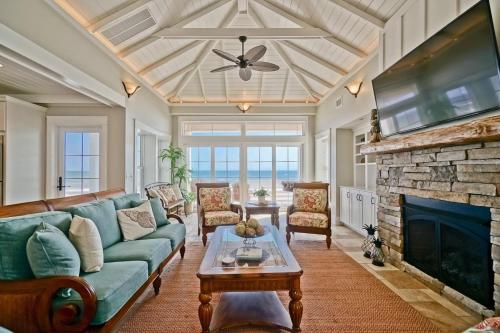 a living room with a couch and a fireplace at Cinnamon Sands home in Holden Beach