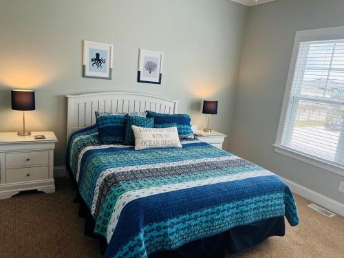 a bedroom with a bed with a blue comforter at 287 OBW home in Holden Beach