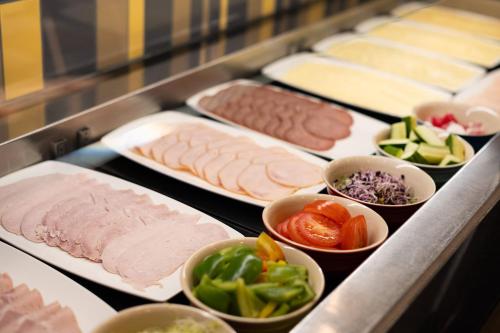 a buffet of different types of meats and vegetables at INNSiDE by Meliá Wolfsburg in Wolfsburg