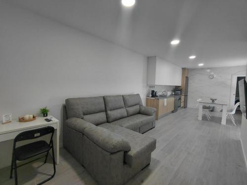 a living room with a couch and a kitchen at Corvera Guss in Corvera