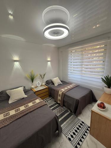 a bedroom with two beds and a large ceiling at Salou Guesthouse in Salou