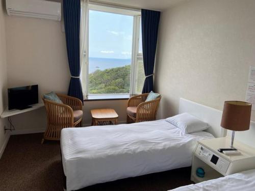 Postel nebo postele na pokoji v ubytování Hotel Cliffside