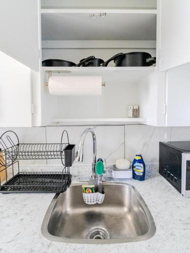 a kitchen counter with a sink in a kitchen at Luvienna Stays in Winnipeg