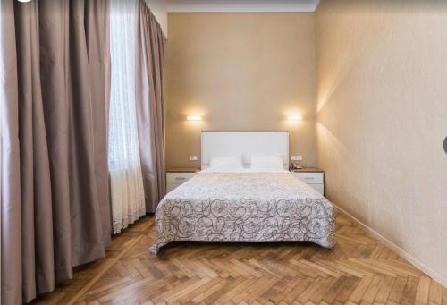 a bedroom with a bed and a large window at G40 Boutique Hotel in Odesa