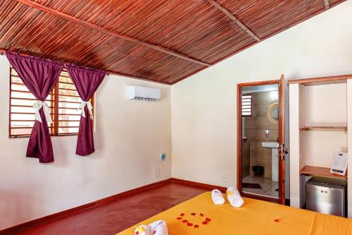 a bedroom with a bed and a window at Blue Sky Resort in Nosy Be