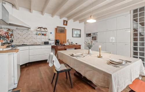 a large white kitchen with a table and chairs at Charmante Maison 