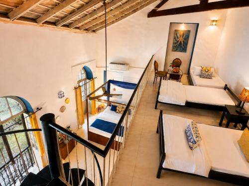 a room with bunk beds and a room with a couch at Casa Do Leão - Heritage Boutique Stay in Nerul