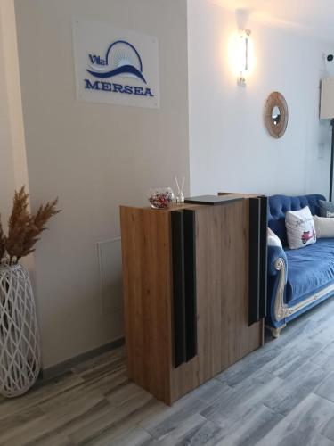 a tv stand in a living room with a couch at Vila MerSea in Mamaia Sat/Năvodari