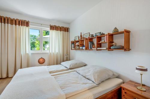 a bedroom with a bed and shelves on the wall at Bernhards in Buch