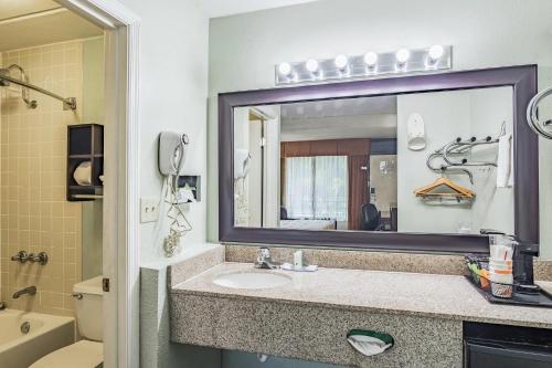 a bathroom with a sink and a mirror at Quality Inn Columbus near Fort Benning in Columbus