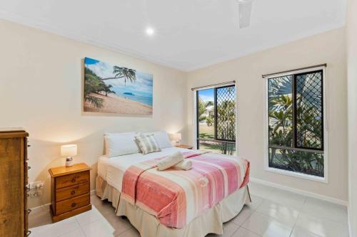 a bedroom with a bed and a large window at The Seahaven - Modern 5 Bedroom Family Home Close to Beach in Pialba
