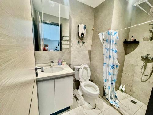 a bathroom with a toilet and a sink and a shower at U Mall Condo in Sihanoukville